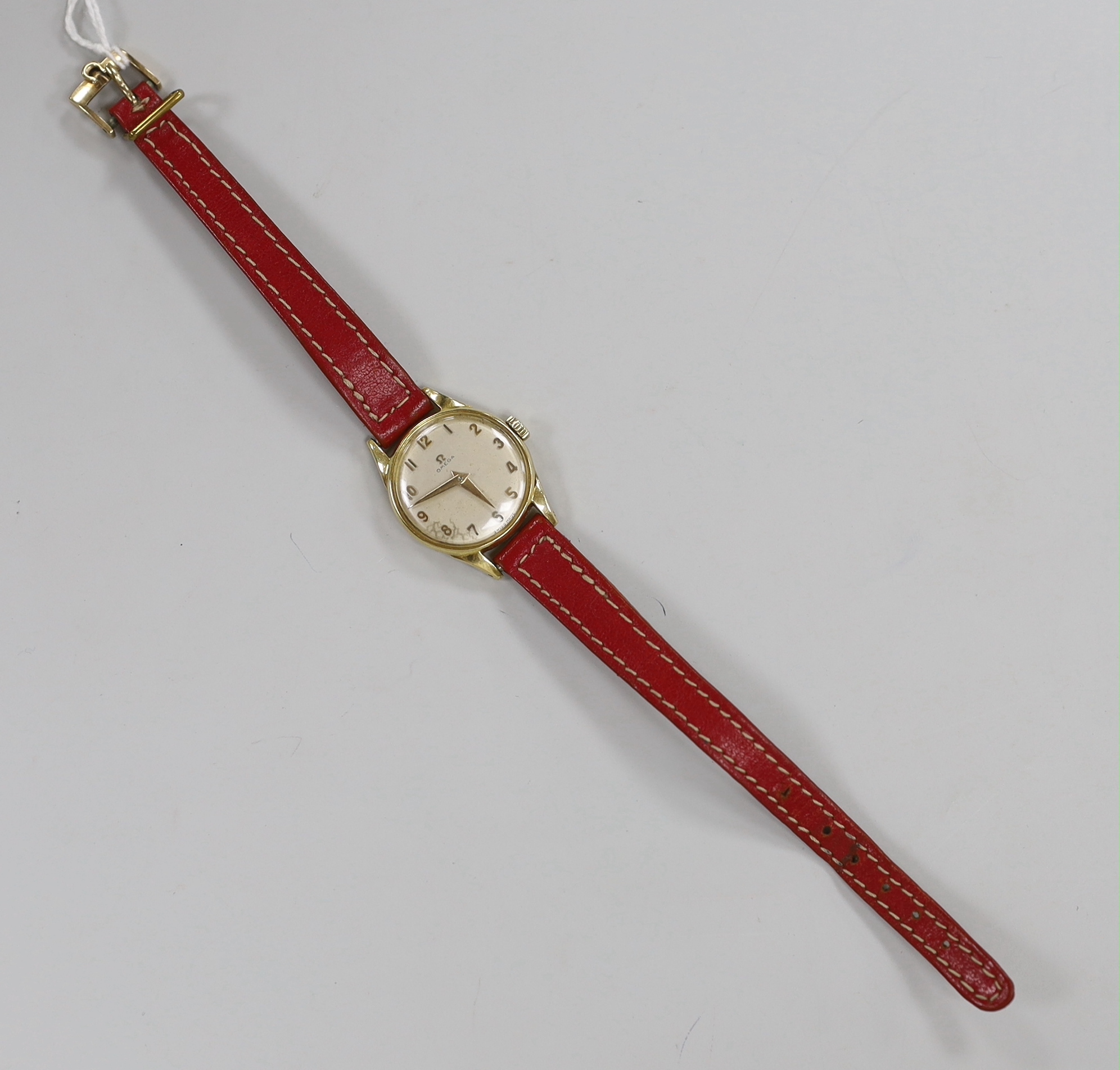 A lady's 18k Omega manual wind wrist watch, on a leather strap with 9ct gold buckle with Omega insignia, gross weight 15.9 grams.